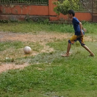 tak-takut-flu-anak-kecil-ini-bermain-bola-sendirian-saat-hujan-lebat