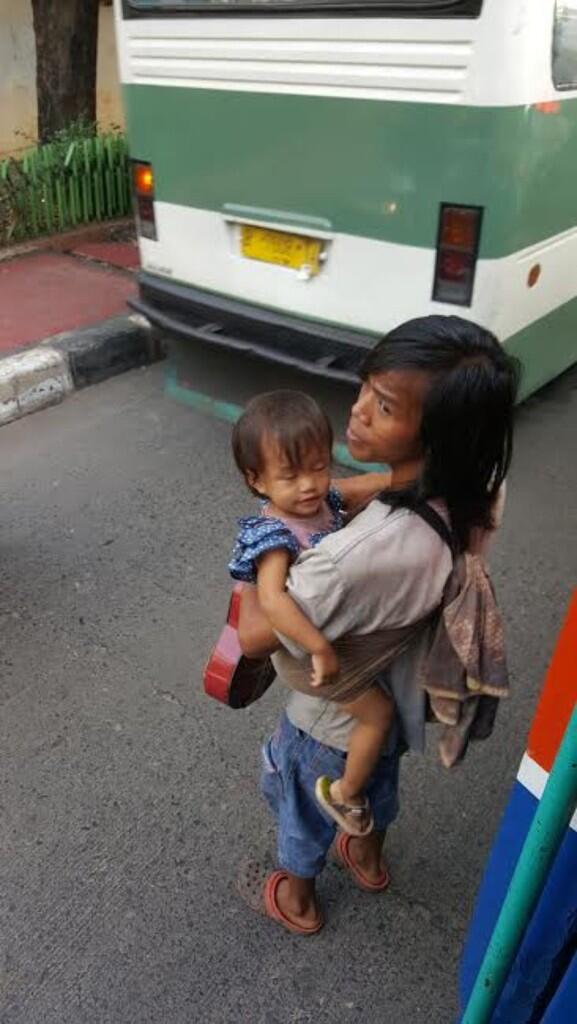 Sambil Gendong Anak, Pria ini Mengamen di Metromini Tujuan Blok M