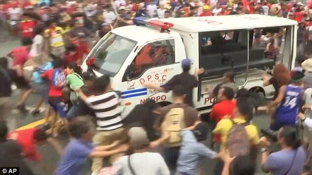 Philippines police ram protesters with a TRUCK during demonstration outside US embass