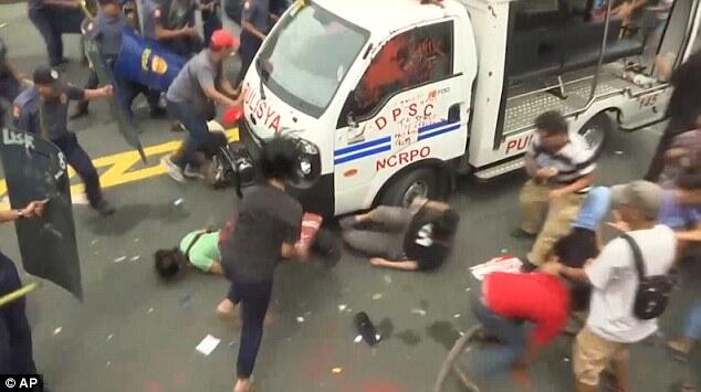 Philippines police ram protesters with a TRUCK during demonstration outside US embass