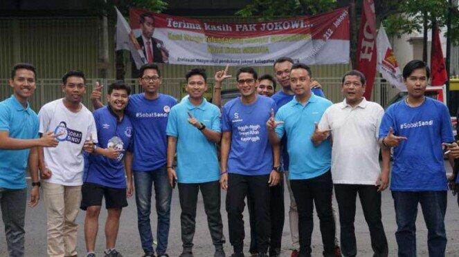 Sandi Foto-foto di Depan Spanduk Jokowi. NGAMUK & Disobek-sobek kah ???