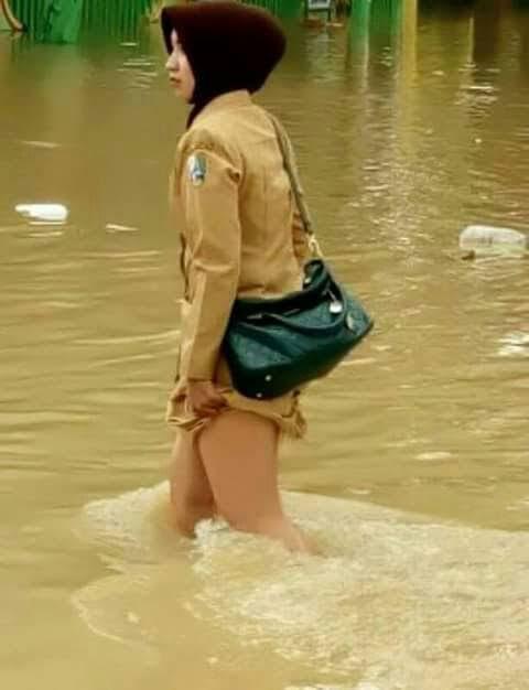 Musim Banjir Tiba, Repotnya Bagi Wanita Yang Bekerja Harus Berjalan Di Arus Banjir
